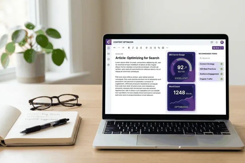 Laptop showing a Surfer SEO-style content editor with a live word count and rising SEO score gauge